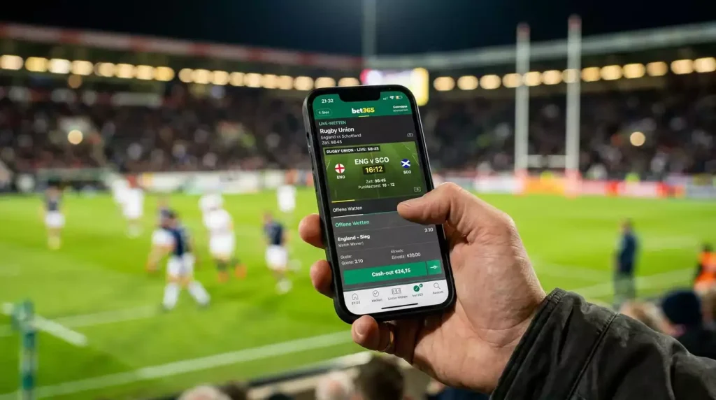 Smartphone mit Live-Wettübersicht eines Rugbyspiels und hervorgehobener Cash-Out-Schaltfläche
